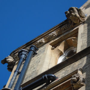 Gargoyles above grasshopper on clock