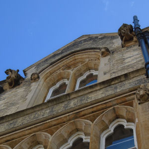 Gargoyles above grasshopper on clock
